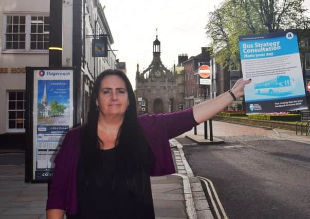 Lesley Gilbert, county council passenger transport planner, with a poster promoting the bus consultation