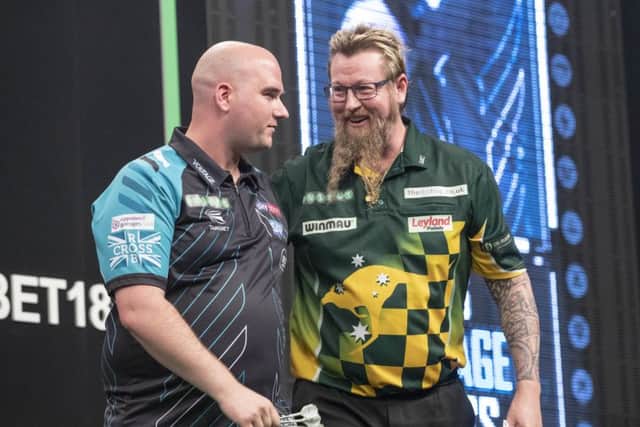 Rob Cross and Simon Whitlock in conversation after their 6-6 draw. Picture courtesy Steve Welsh/PDC
