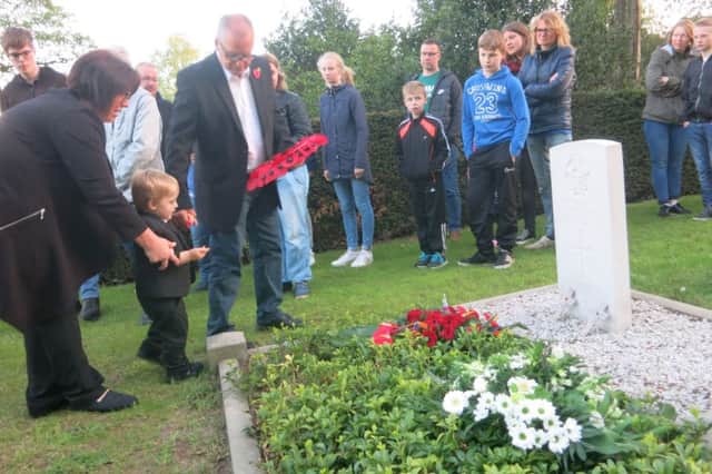 Little Teejay Woollard and his father Alan at the war hero's grave