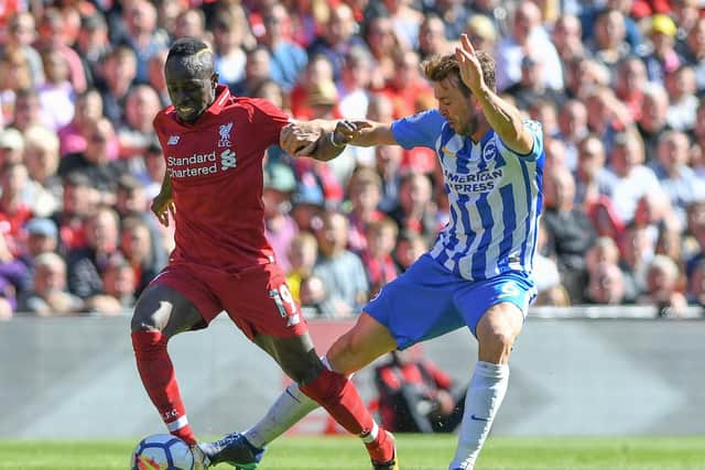 Dale Stephens challenges Sadio Mane. Picture by Phil Westlake (PW Sporting Photography)