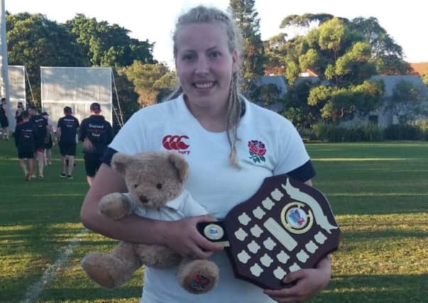 Sharn-Louise Watson clutches the shield and the England team mascot.