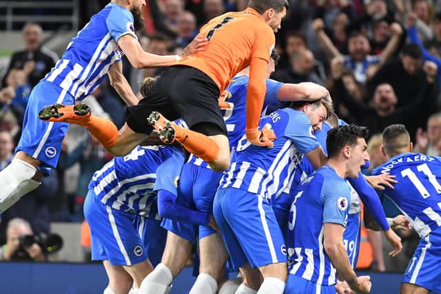 Albion players celebrate Pascal Gross's goal against Manchester United. Picture by Phil Westlake (PW Sporting Photography)
