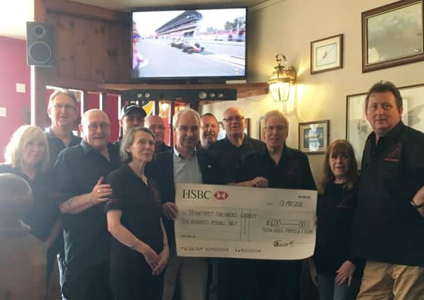 The Piston Broke Formula One Club presents the cheque to Hugh Whittaker from The Honeypot Children's Charity