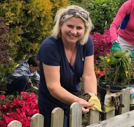 Dozens helped tiday Ann Sandeman's garden on Sunday