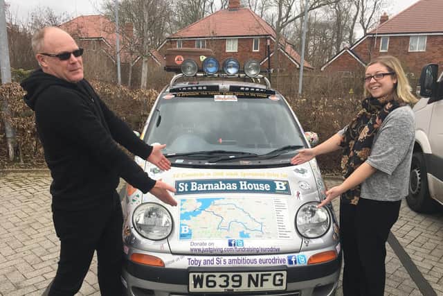 Toby Harris with his car, and the route they are taking on the bonnet