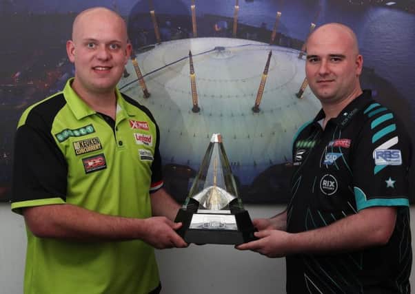 Rob Cross (right) and Michael van Gerwen stand alongside the Unibet Premier League trophy. Picture courtesy Lawrence Lustig/PDC