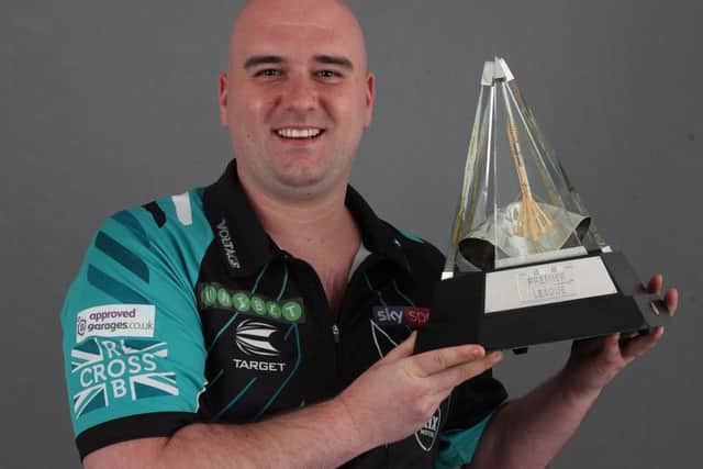 Rob Cross holds the trophy aloft. Picture courtesy Lawrence Lustig/PDC