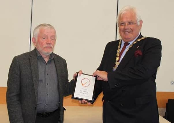 John Pickersgill, club trustee, receives the award from Cllr Burgess