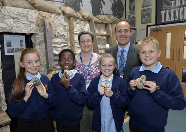 Year 4 children and staff with their Secret Stones Project at Langney County Primary School Eastbourne. L-R, Lexi, Joseph, Evelyn, Jayden with Michelle Pollard and HT Ben Bowles (Photo by Jon Rigby) SUS-180517-095251008