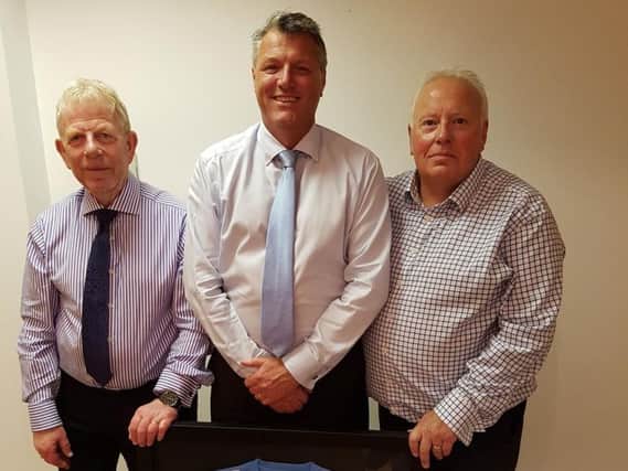 Worthing United sponsor Peter Saywell, new chairman Bill Clifford and secretary Mark Sanderson