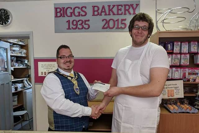 Billy with Mark Biggs at Biggs Bakery in Wick. Mark presented Billy with a cheque for Â£120 towards mayoral fundraising efforts from the sale of mayor's cakes