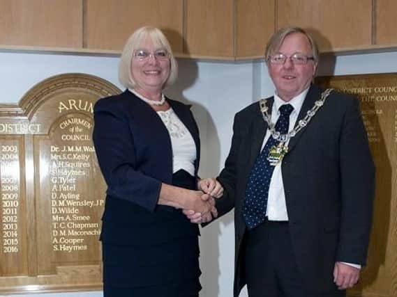 Chairman councillor Alan Gammon shakes hands with councillor Jacky Pendleton.