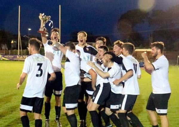 Pagham under-21s lift the west division trophy / Picture by Roger Smith