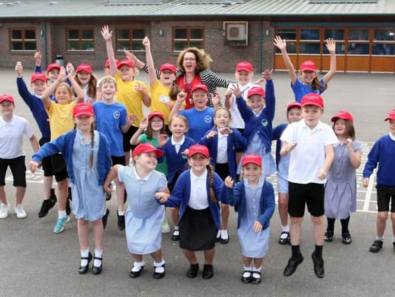 Headteacher Sue Harrison and some of her pupils celebrate Steyning Primary School's good Ofsted report
