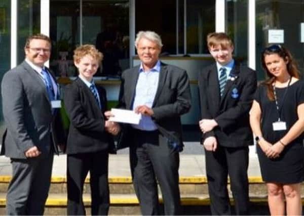Gerald Illsley delivering the Rotary Club of Worthing Steynes donation to Chatsmore High School
