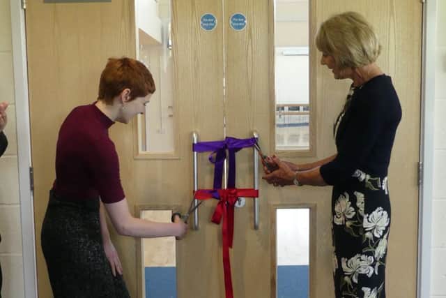 Ruth Harding and Ella Fleetwood cutting the ribbon at the opening