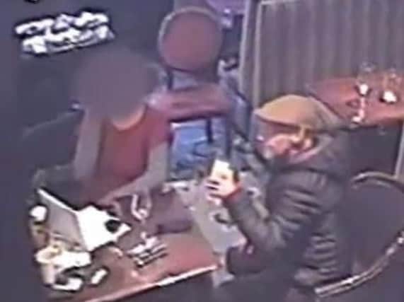 CCTV image of a man police want to speak to in connection with a theft in a Brighton pub