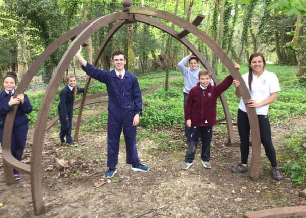 Emma Pledger (right) and the pupils at Great Ballard School starting work on their arbour, funded by Miller Homes Southern