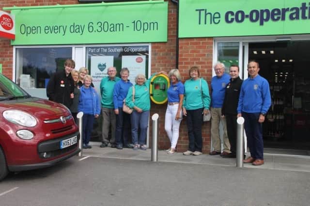 Members of Southbourne Lions Club and staff from Southbourne Co-op with the defibrillator