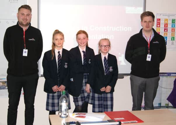 Year Seven students with two Galliford Try employees.  Dean Lancaster, on the right, is an ex-student who is now working as a quantity surveyor with Galliford Try