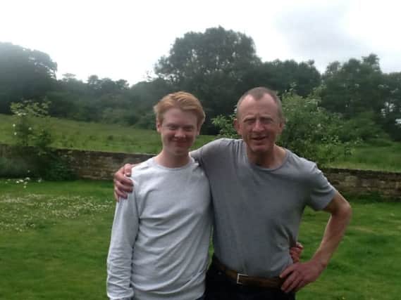 Mark Clark who has a brain tumour is taking on a skydive for charity. Pictured with his son Oliver SUS-180406-172527001