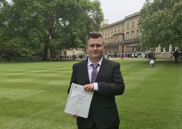 Jordan Butterfield with his certificate at Buckingham Palace