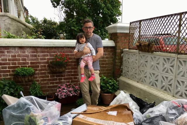 Wayne McConnell with his daughter outside his flat in South Terrace, Littlehampton