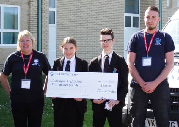 Hope Waite-Jones and Eddie Pullen from Durrington High School were presented with a Â£500 cheque for the school by Coastal Drains