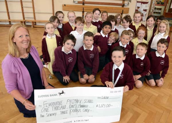 ks180270-1 Fishbourne Primary Cheque  phot kate
Alfie McDermott, eight, front right, giving a cheque to Naomie Day, headteacher of Fishborne Primary. Alfie raised the money from a sponsored walk and raffle.ks180270-1 SUS-180506-140701008