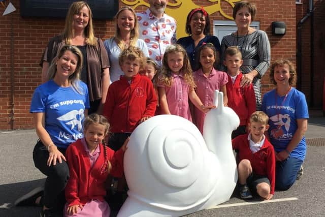Children, parents and headteacher from West Hove Infants School take delivery of their junior snail alongside learners ambassador Nick Sharratt