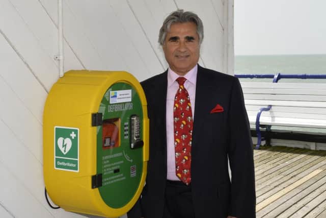 Sheikh Abid Gulzar with the defibrillator on his Eastbourne Pier (Photo by Jon Rigby)