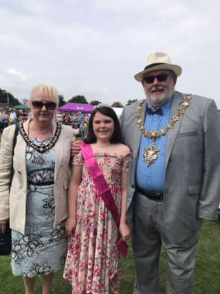 Carnival Princess: Mayor Paul Baker and his wife Sandra presenting an award to Holly Elves for her donation of 12 inches of hair to the Little Princess Trust SUS-181206-143339001