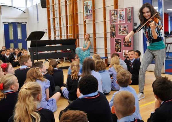 Violinist Kamila Bydlowska goes walkabout during the performance at Chesswood Primary School. Picture: Stephen Goodger