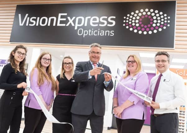 East Worthing and Shoreham MP Tim Loughton cuts the ribbon to open Vision Express at Tesco in the Holmbush Centre
