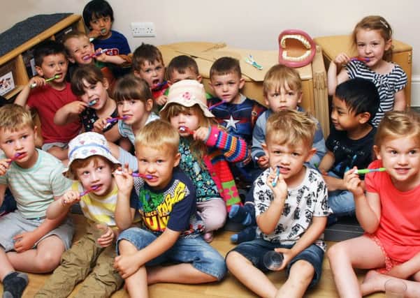 Learning good brushing techniques at Little Rascals Day Nursery in Worthing. Picture: Derek Martin DM1862400a