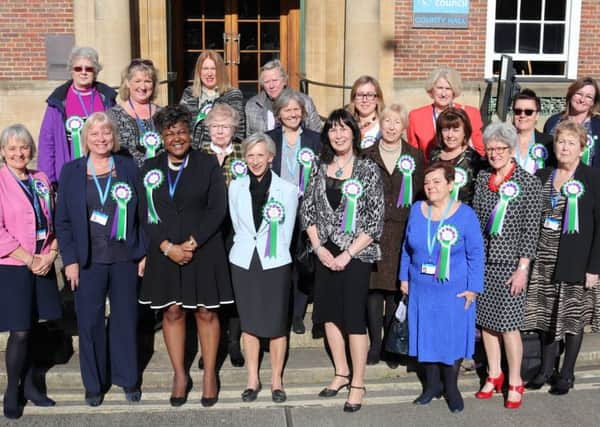 Female county councillors outside County Hall in February wearing rosettes to mark 100 years since legislation was passed giving some women the vote for the first time in the UK