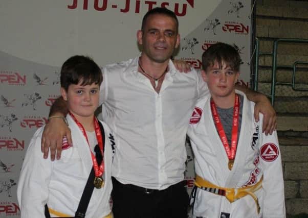 Soni and Kiri Dauti, of Gracie Barra Hastings, wearing their gold medals at a Brazilian Jiu Jitsu tournament in Albania.