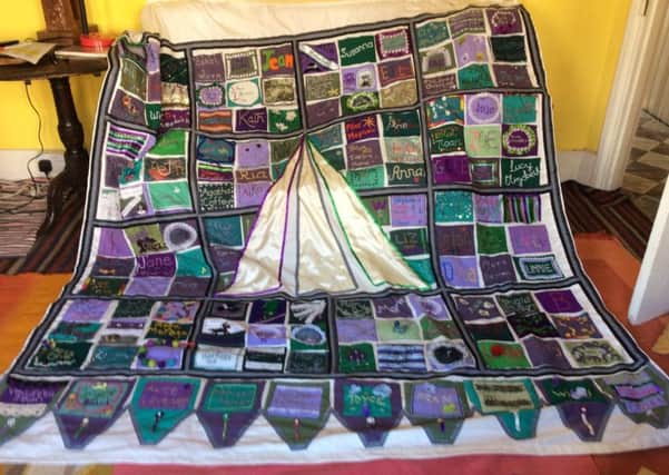 Made by local women, the banner consists of 157 squares, each carrying a womans name. SUS-180619-115754001