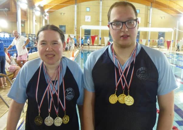 Kirsty Stewart and Tristan Curtis wearing the medals they won at the Leatherhead Swans Annual Swimming Gala.