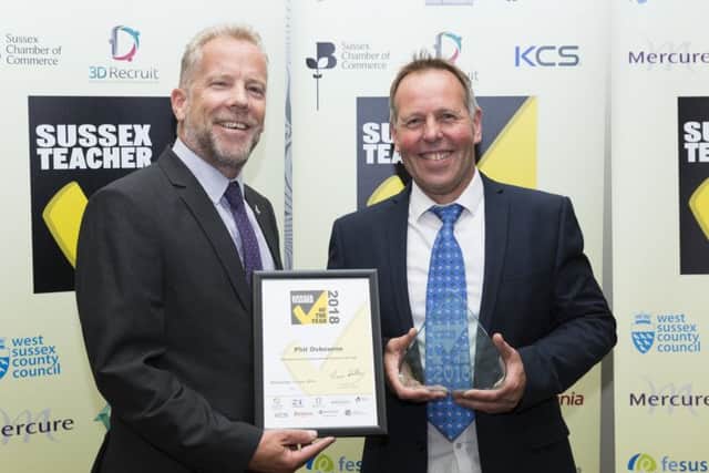 Paul Hills from the  Chamber of Commerce presents Philip Osborne of Willingdon Community School with his Overall  Sussex Secondary School Teacher of the Year award (Photograph: Martin Apps)