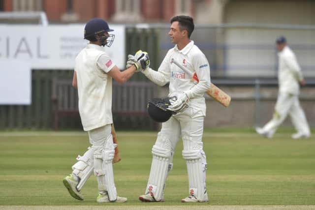 Horsham CC's Tom Haines celebrates is century with Nick Oxley who scored 50 against Eastbourne at The Saffrons (Photo by Jon Rigby) SUS-180618-114413008