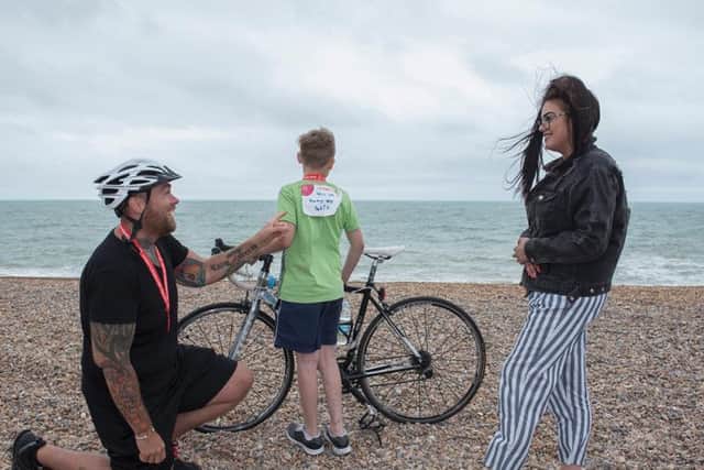 Doug, 33 proposed to his girlfriend, Summer 25 at the finish line of the London to Brighton Bike ride with the help of his son Cameron 12 (Photograph: Danny Fitzpatrick)