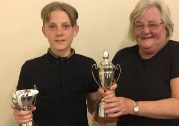 Jesse Smith receives his best junior novice boxer trophy at the Sussex Boxing Awards from Sussex ABA secretary Carol Jones.