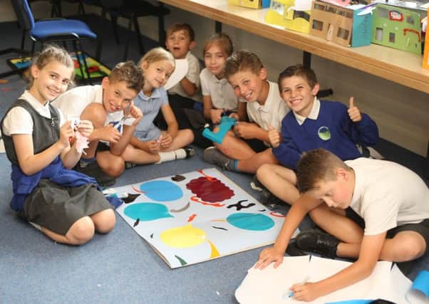Steyning Primary School pupil cutting out shapes for their artwork. Picture: Derek Martin DM1864636a