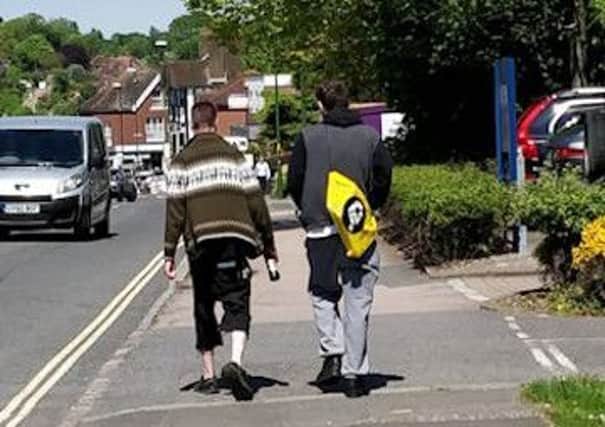 Police are looking to trace these men in connection with racist graffiti discovered in Mid Sussex