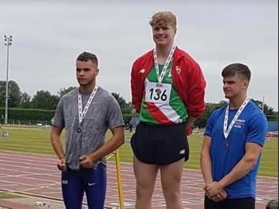 Hammer thrower Ben Hawkes stands tallest on the podium at the Southern Championships