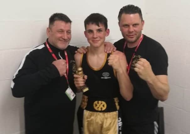 The victorious Josh Cato alongside Bexhill Amateur Boxing Club coaches Tone Godwin and Terry Freeman.