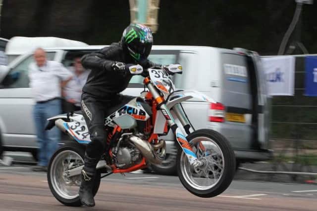 Watch motorbikes and cars speed down the seafront