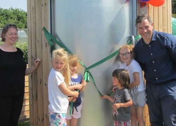 Jeremy Quin MP, second on the right, cuts the ribbon on the compost loo