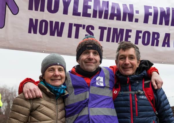 Race director Duncan Rawson (centre) with husband and wife Lewis Sida and Helen Sida who were first man and first woman home in this year's marathon. Photograph by Barry Collins